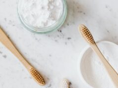 jars with tooth powder and wooden toothbrushes